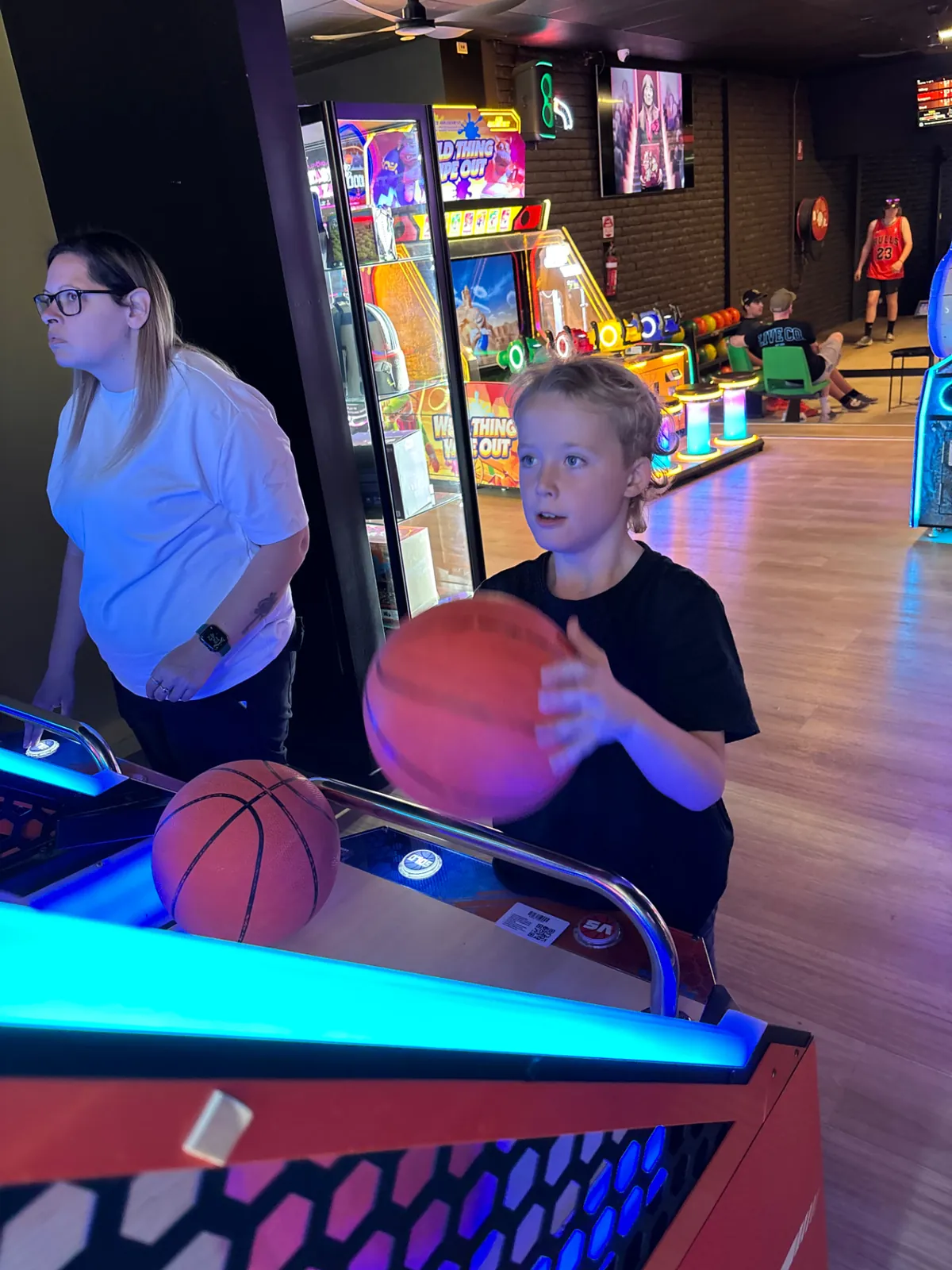 Child playing an arcade basketball game at a Bendigo Bowl kids party