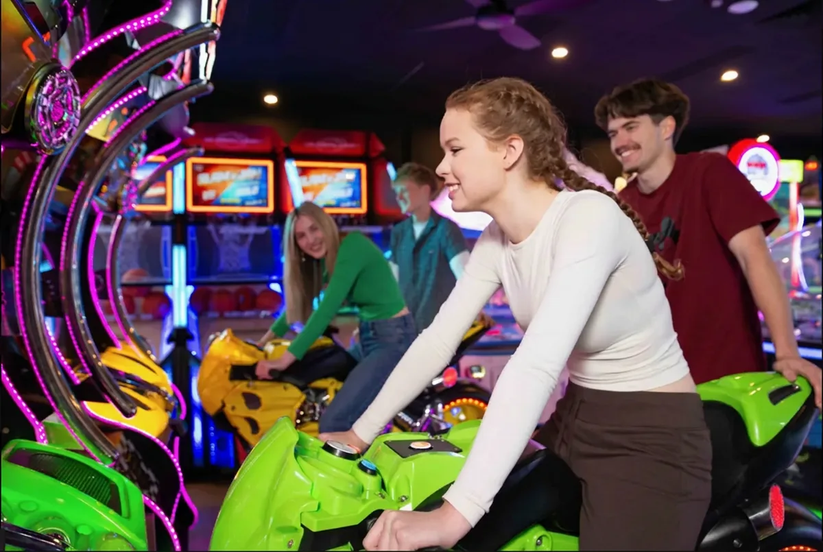 Friends racing on the motorbike arcade games at Bendigo Bowl