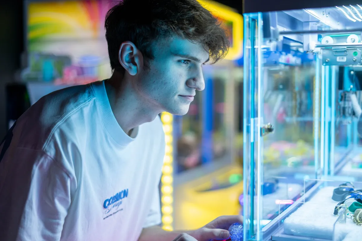 Teenager lining up a grab on the claw machine at Bendigo Bowl