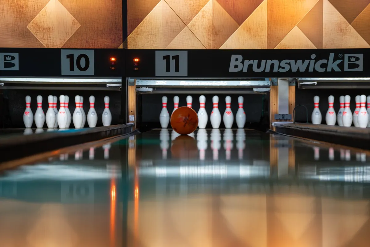 Ten-pin bowling pins with a pink bowling ball on a Bendigo Bowl lane
